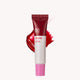 Red and white lip balm tube with pink cap on a white background