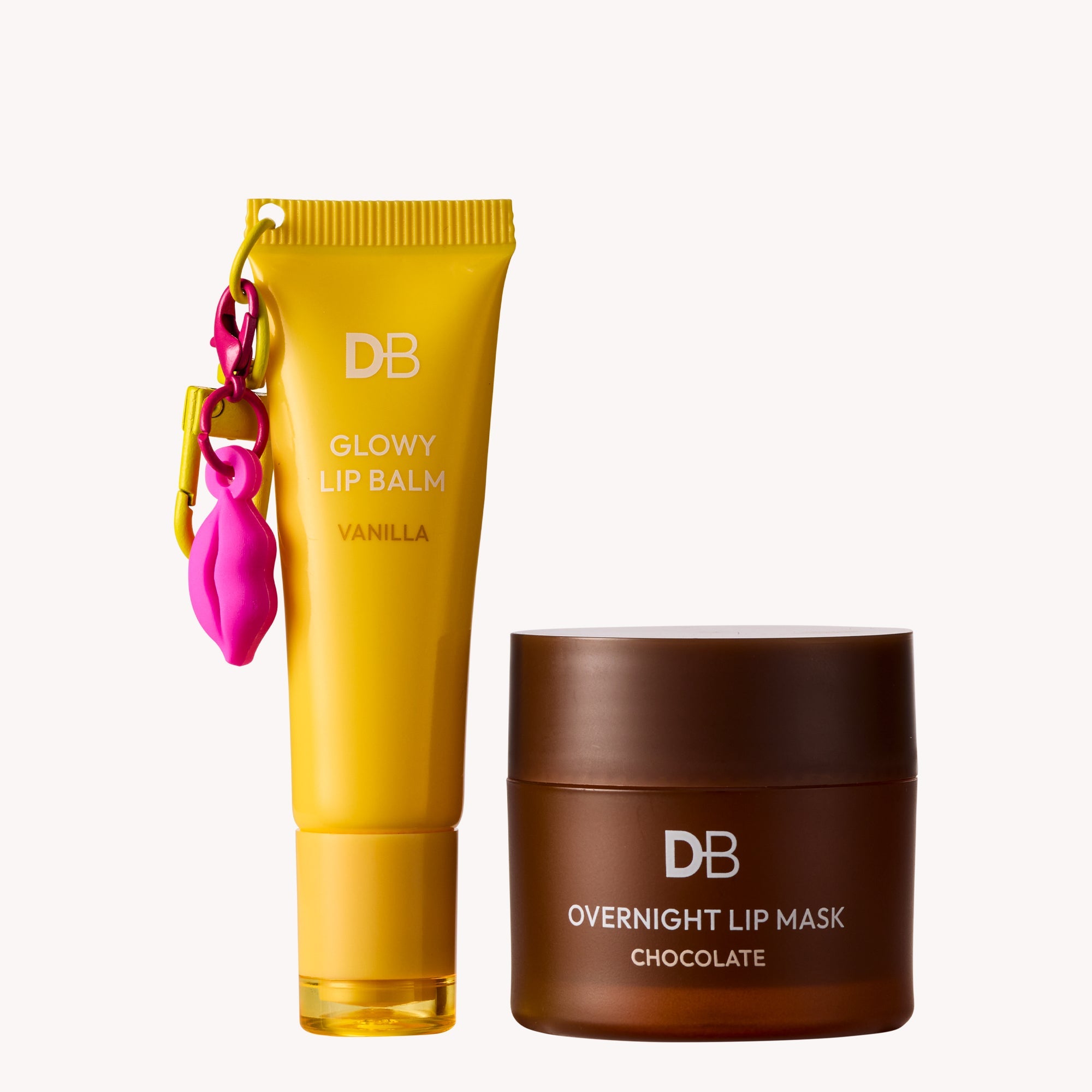 Yellow lip balm tube and brown lip mask container with 'DB' branding on a white background