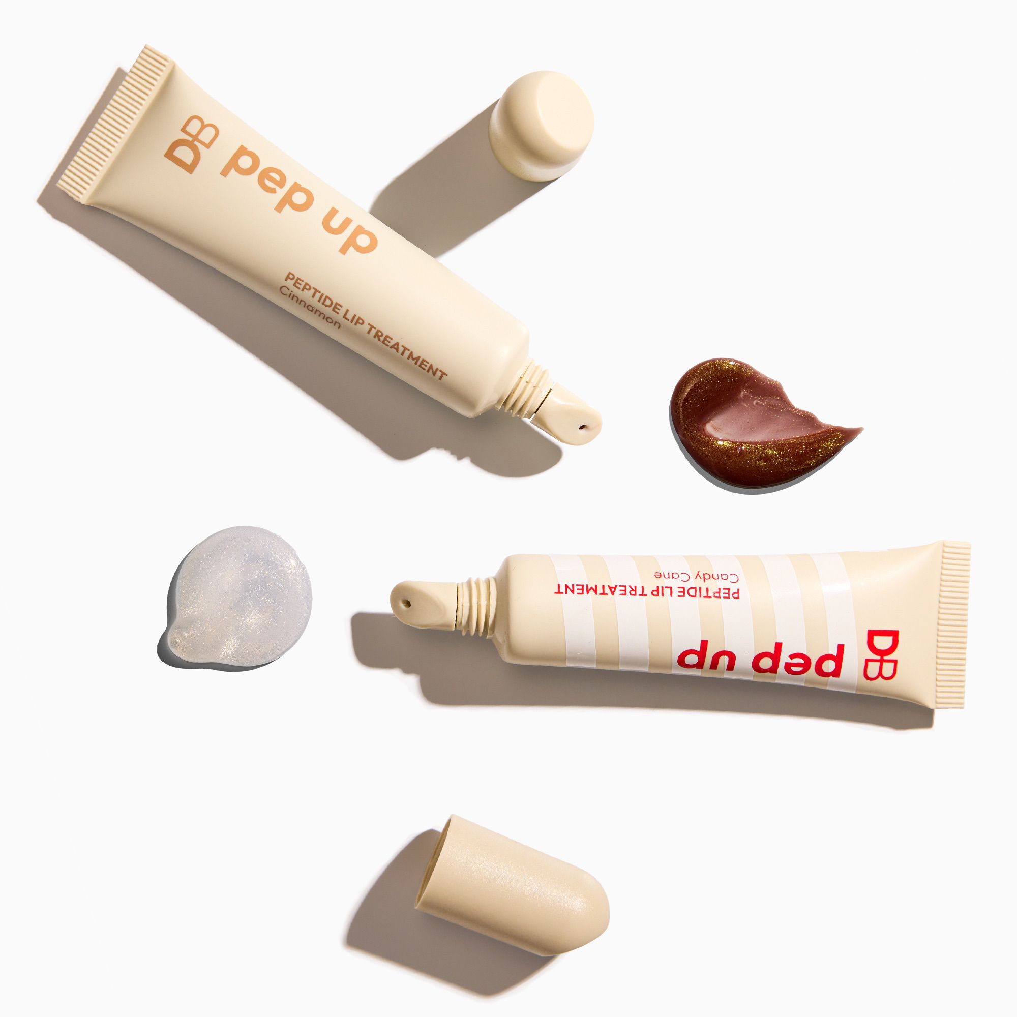 Two tubes of DB Pep Up lip treatment on a white background