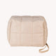 Beige quilted cosmetic bag with a strap on a white background