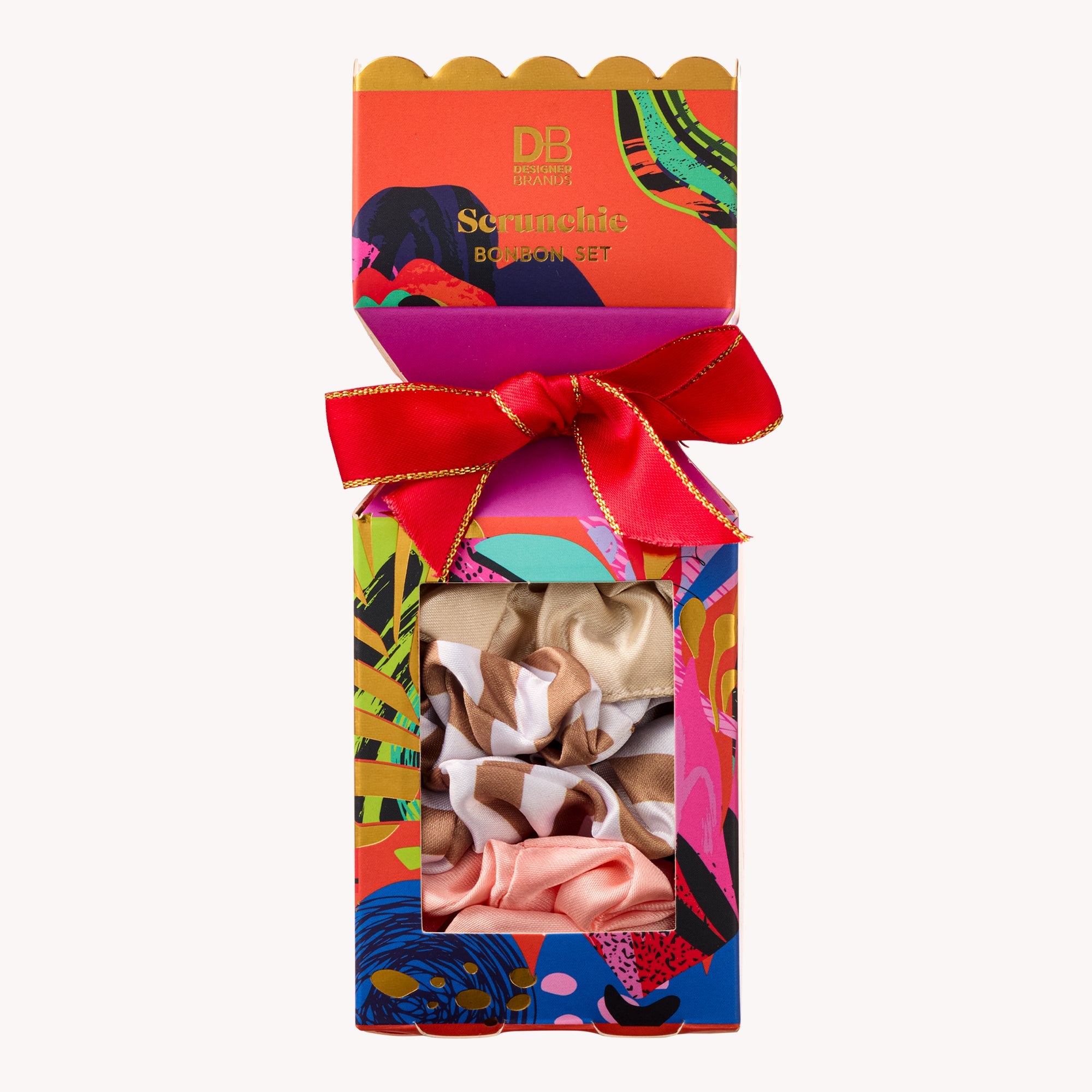 Colorful gift box with a bow containing hair scrunchies, featuring the brand 'DB'.