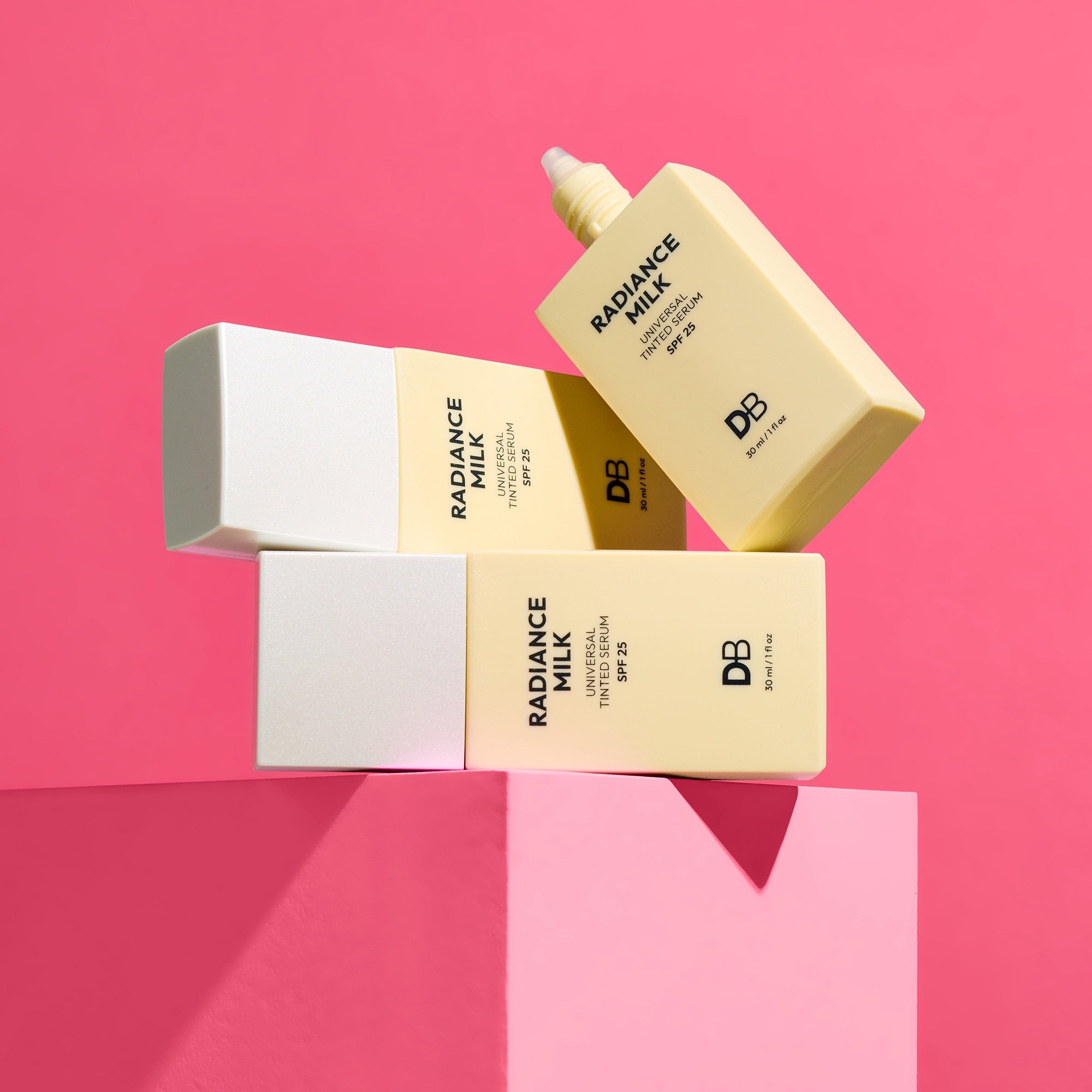 DB Skincare Radiance Milk packaging on a pink background