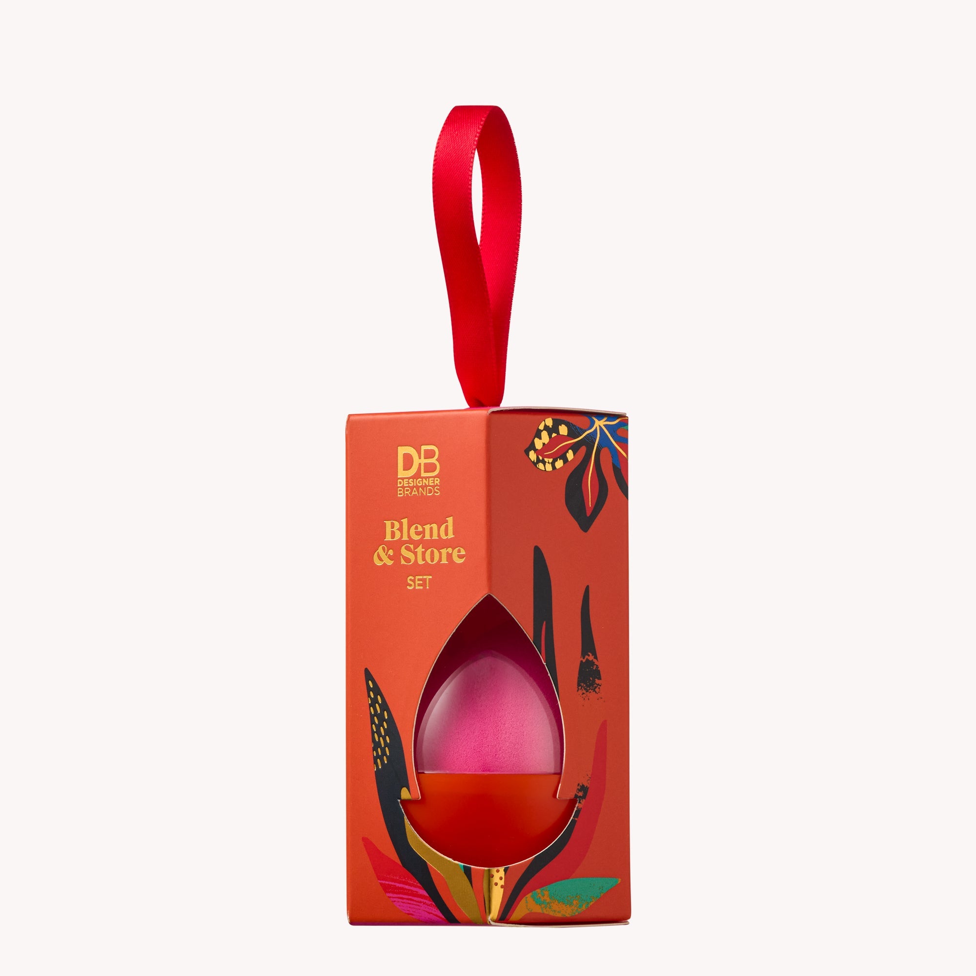 Red packaging box with a pink makeup blender and decorative elements on a white background