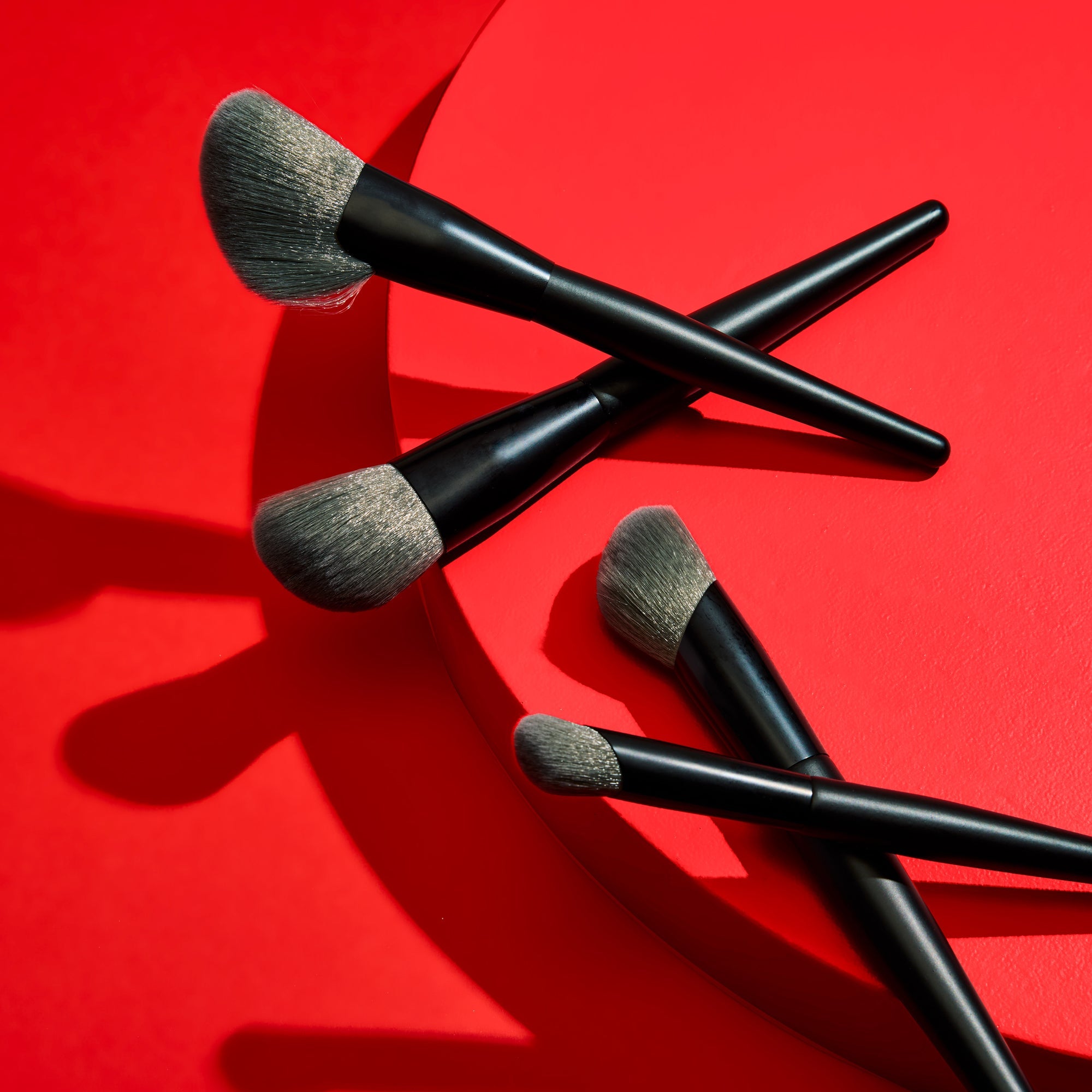 Makeup brushes on a red background