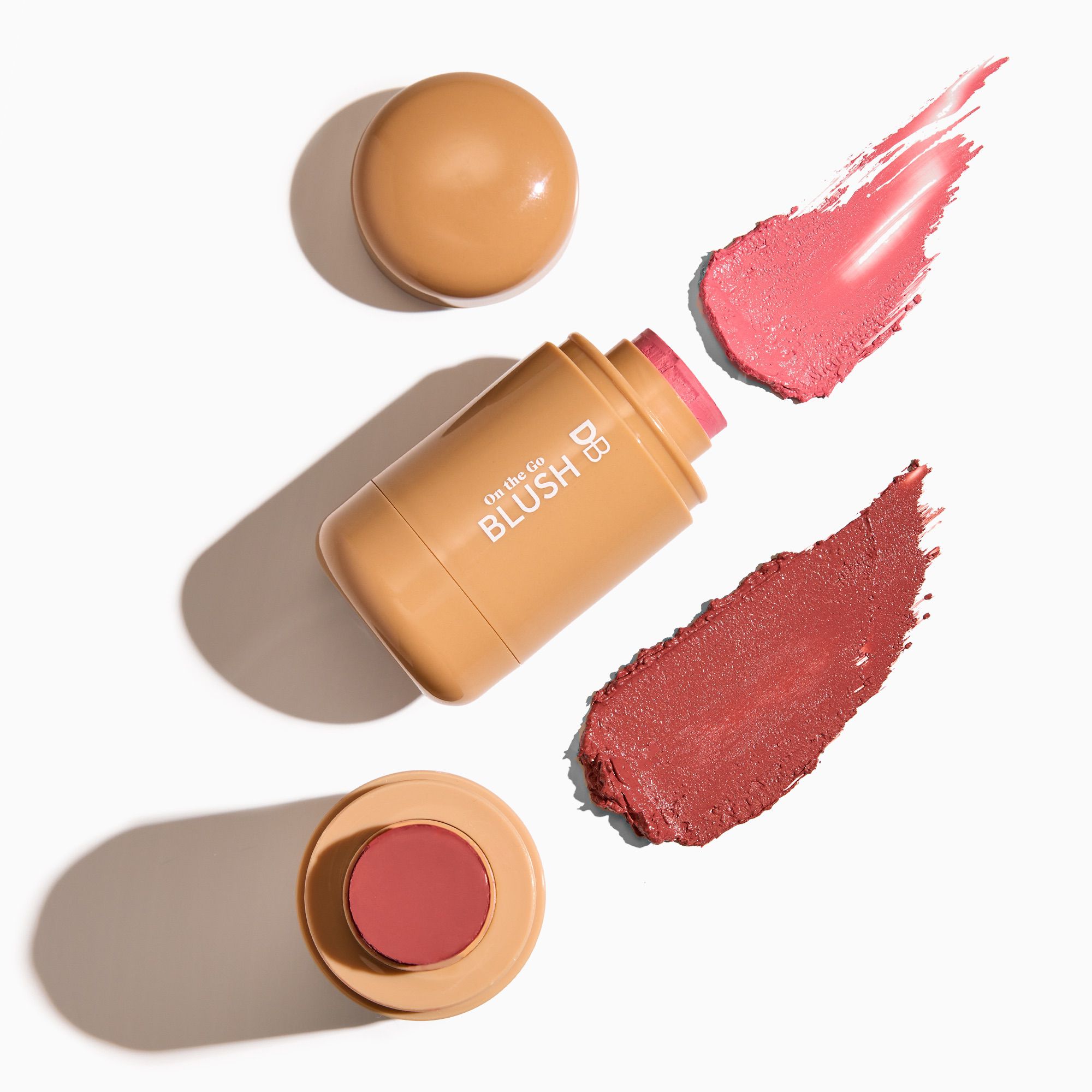 Blush stick with swatches on a white background