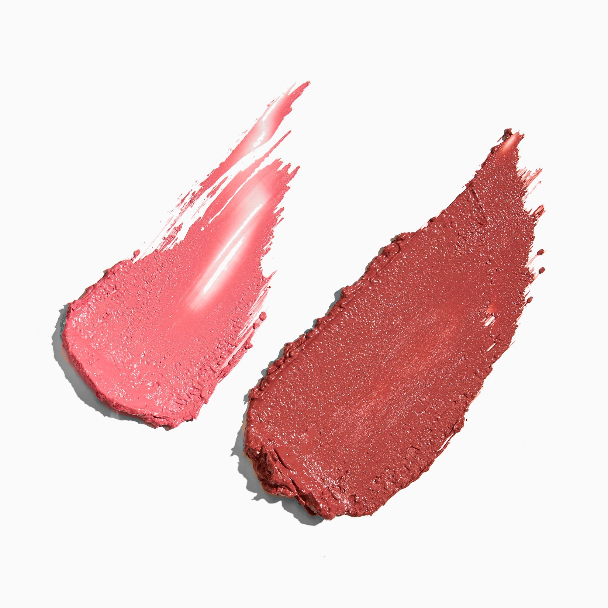 Two swatches of pink lipstick on a white background