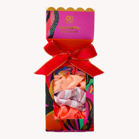 Colorful packaging of a hair scrunchie set with a red bow on a white background