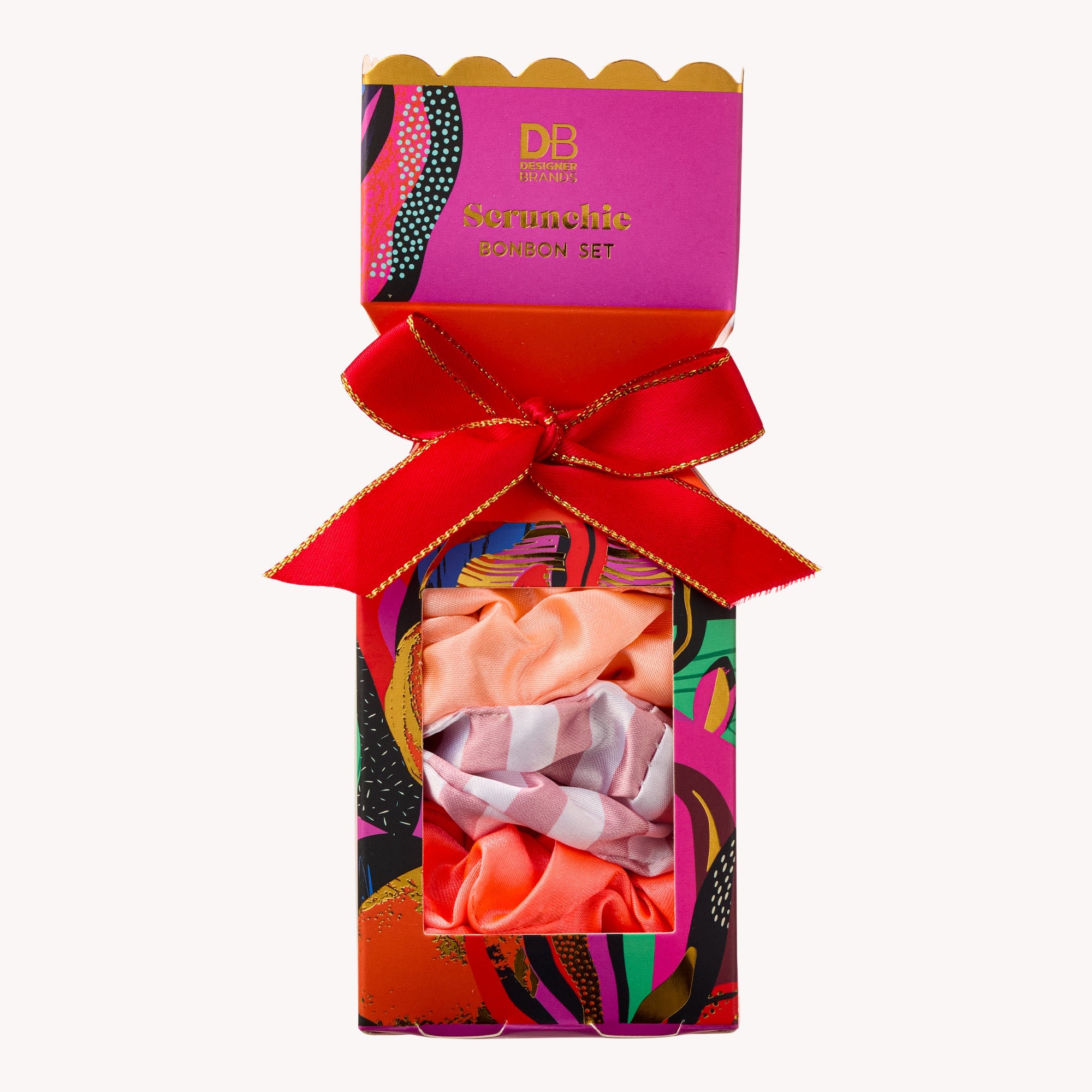 Colorful packaging of a hair scrunchie set with a red bow on a white background
