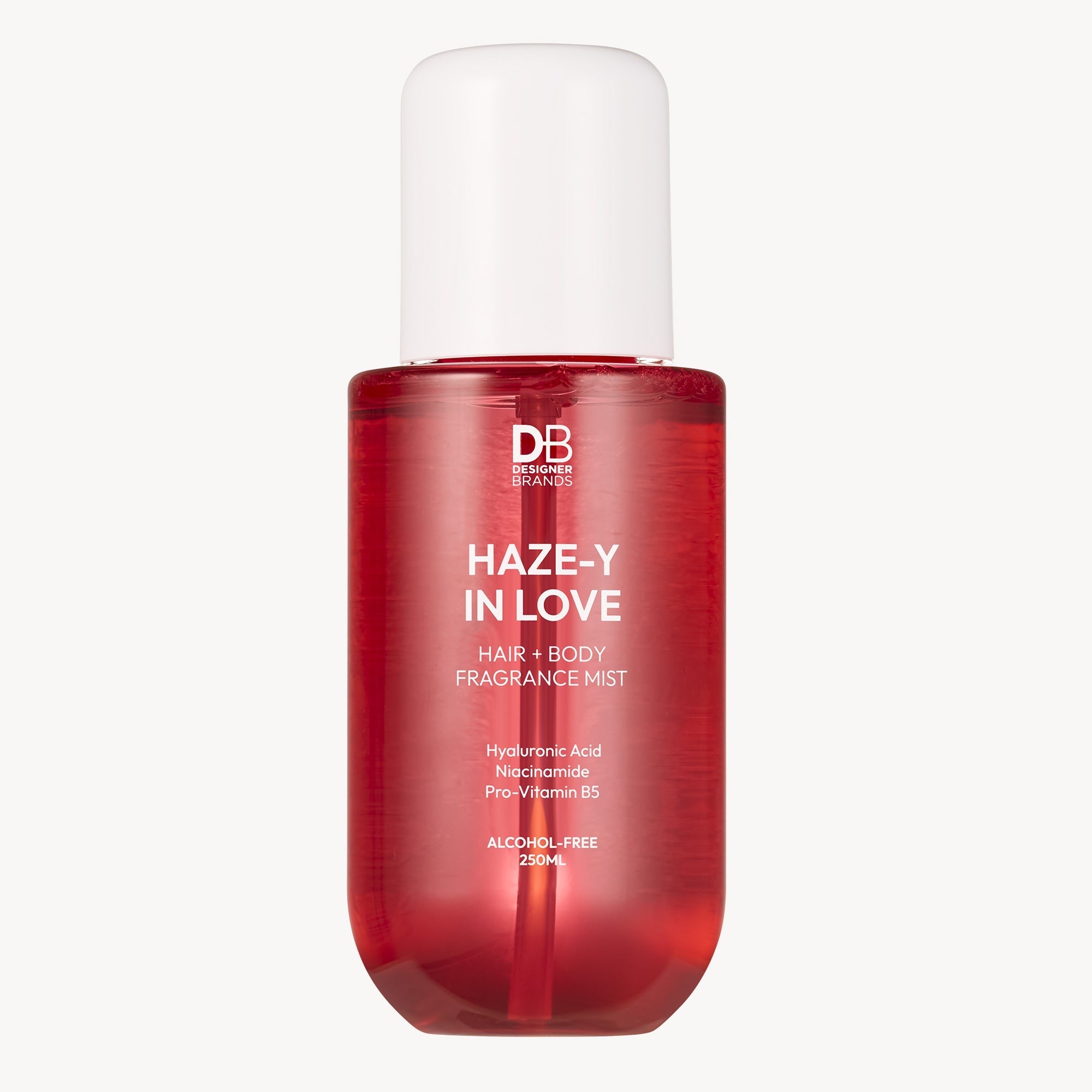 Red bottle of 'Haze-Y In Love' hair and body fragrance mist on a white background