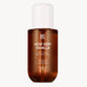 Brown bottle of 'How Very Vanilla' hair and body fragrance mist with a white cap on a white background.