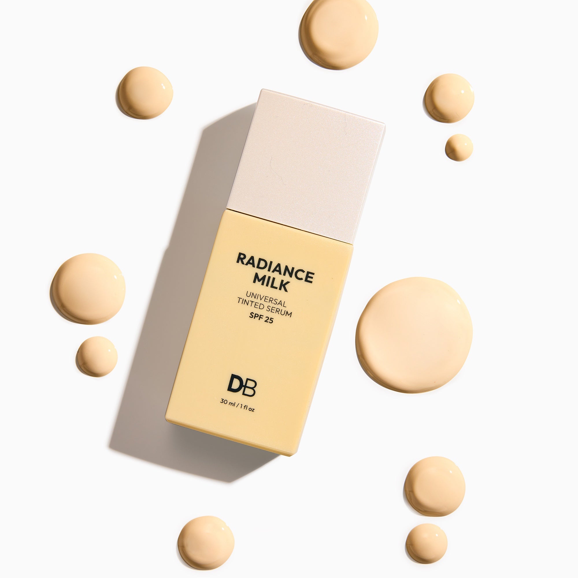 Cosmetic packaging labeled 'Radiance Milk' with cream-colored balls on a light background