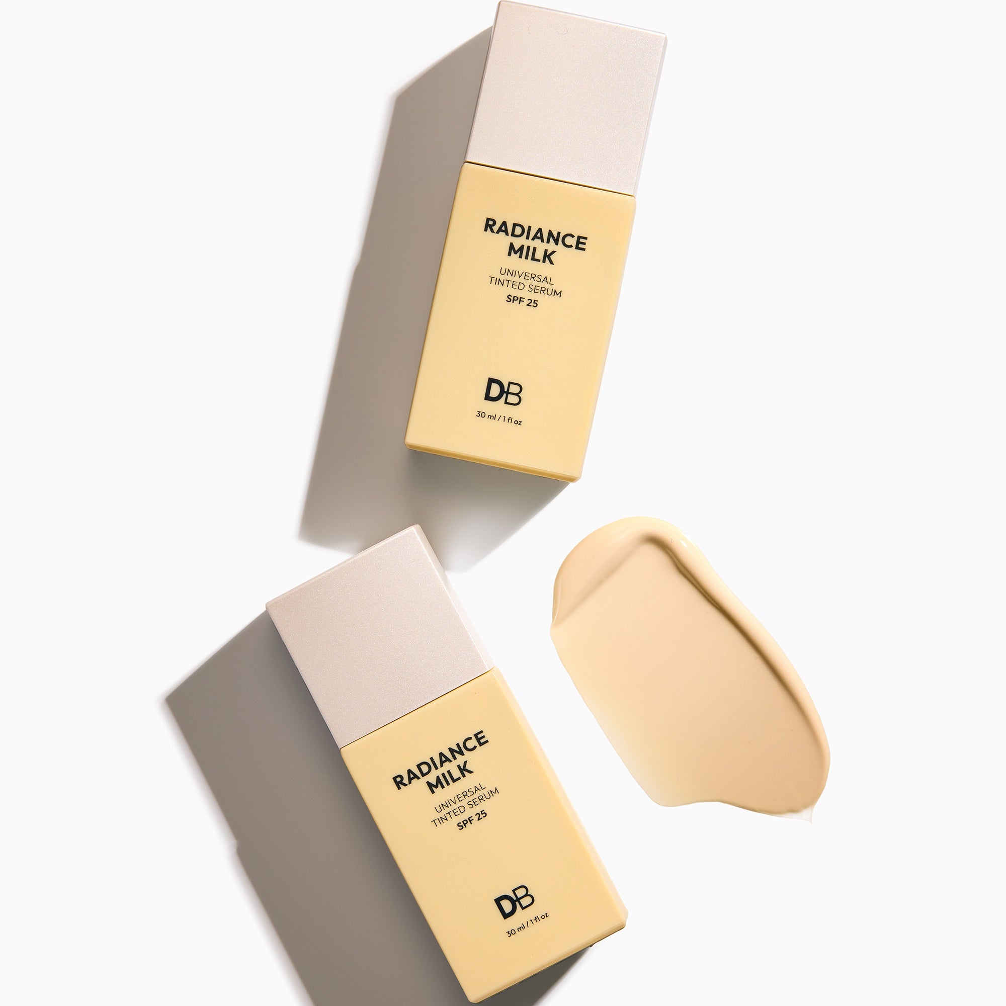 Cosmetic packaging labeled 'Radiance Milk' with swatch on a light background