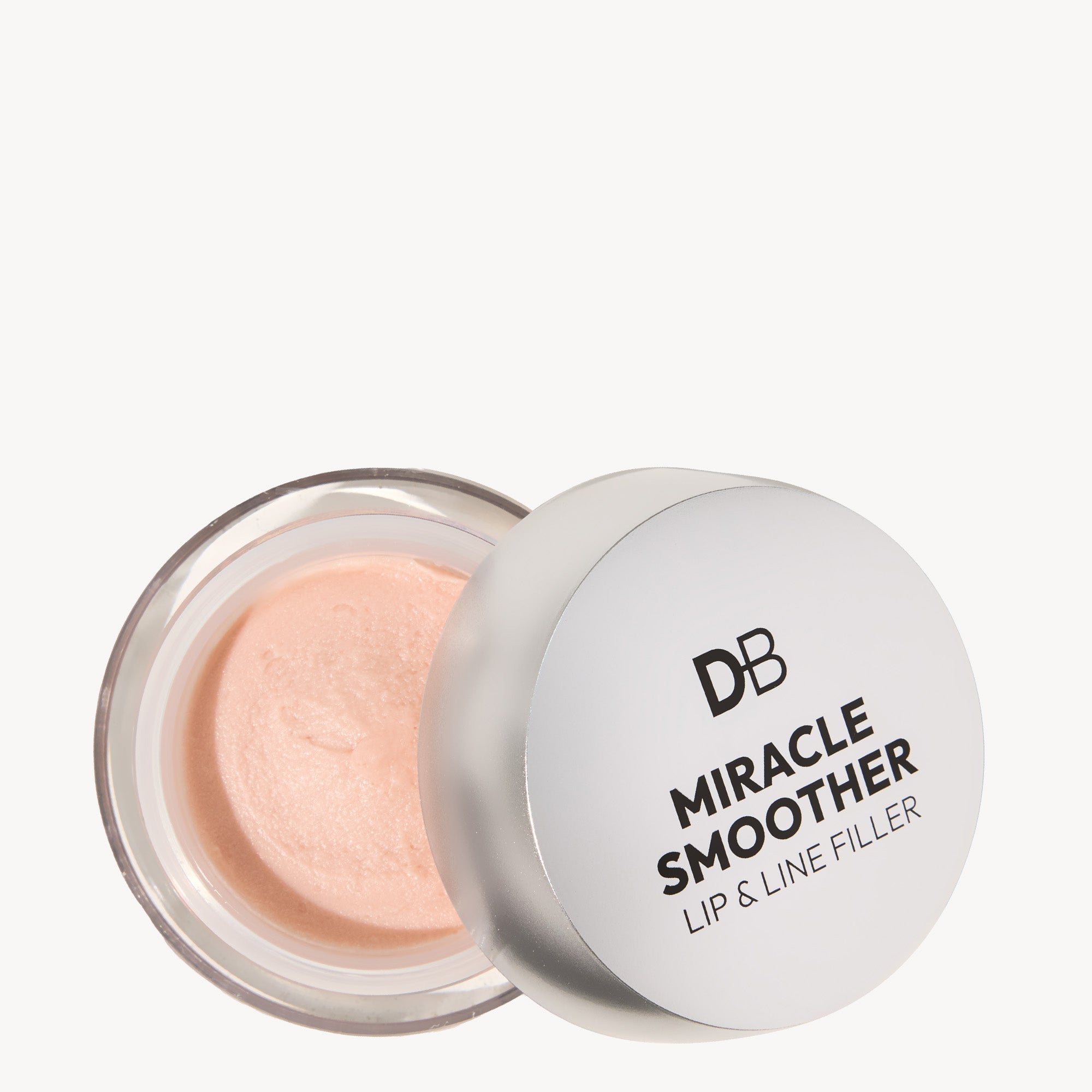 Open container of DB Miracle Smoother Lip & Line Filler, featuring a peach-toned cream and a metallic lid with bold black text.
